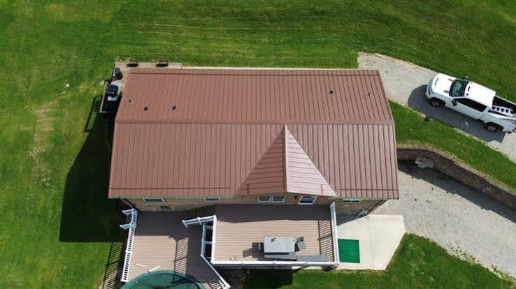 Drone view of a terracotta metal roof installed by New Horizon Roofing