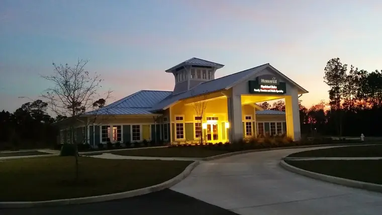 Commercial building at dusk with a finished roof