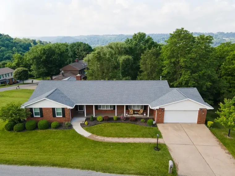 Aerial view of a brick home with a finished roof