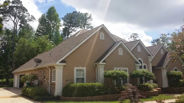 Stucco home with a new shingle roof