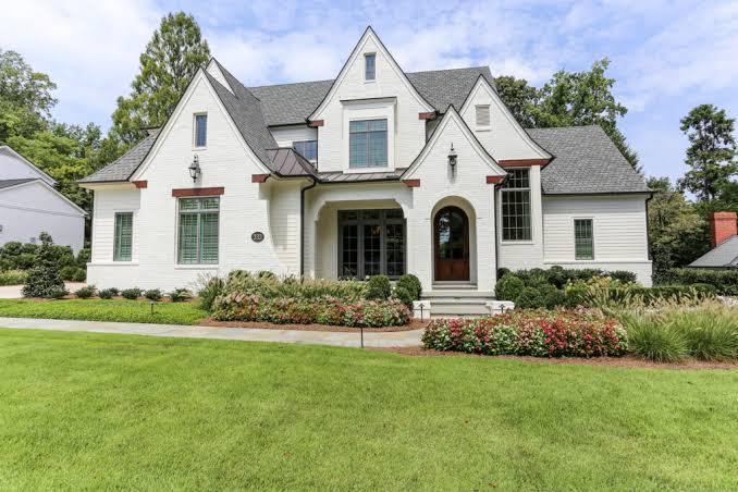 White modern farmhouse with a dark roof