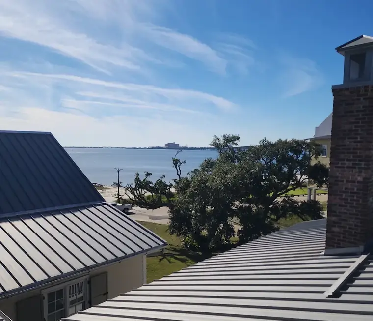 Standing seam metal roof detail overlooking the water